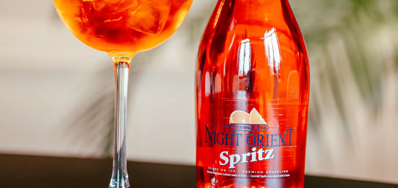 Spritz with a slice of orange next to it